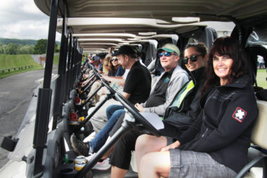 Golfers sit at the ready in their carts before shotgun